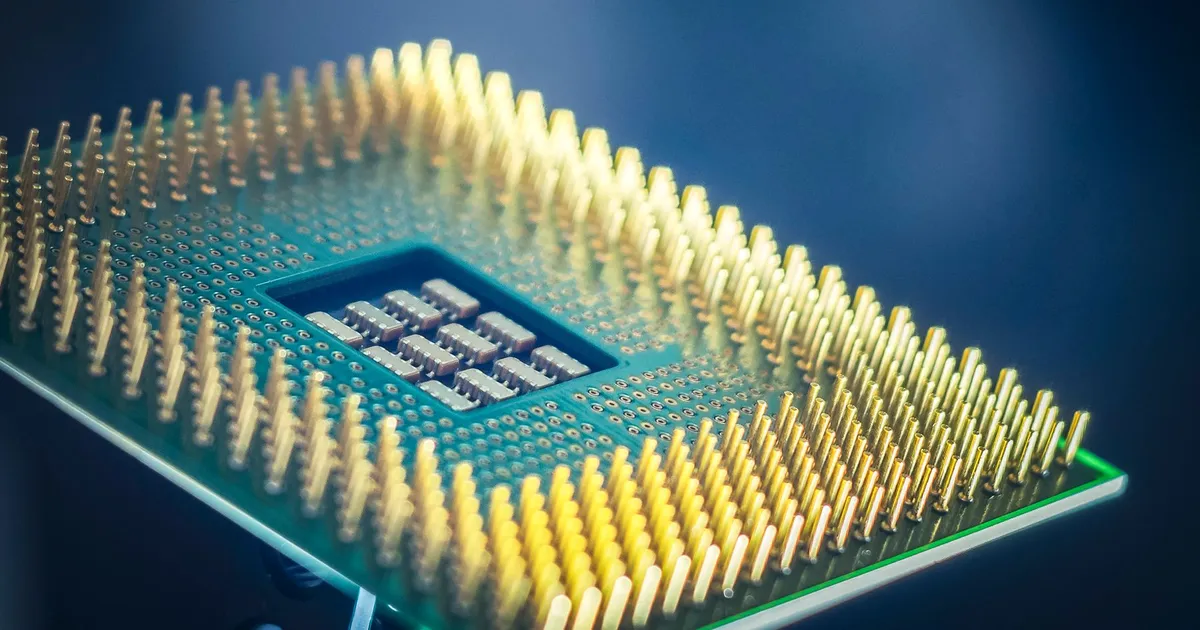 ESD PEEK for semiconductor handling: a close-up of a processor chip with rows of fine contact pins on a blue background